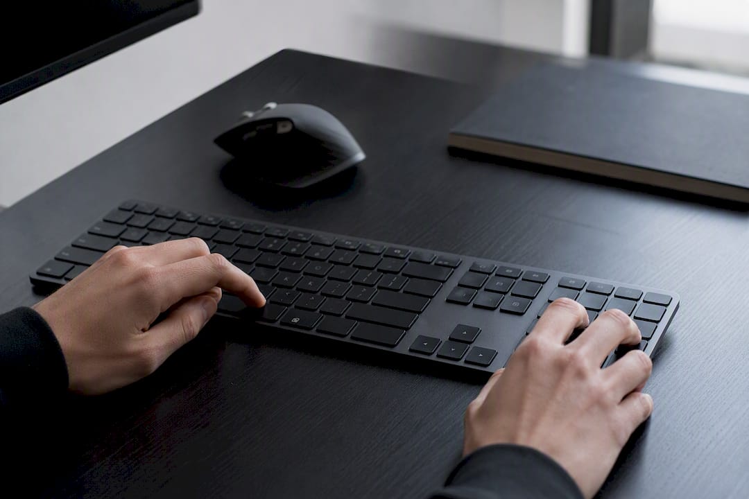 Hands typing trademark shortcut on keyboard