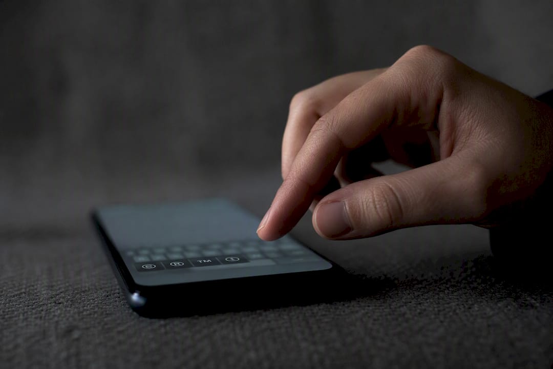 Hand selecting trademark symbol on smartphone keyboard