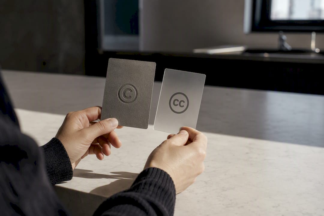 Hands holding copyright and license cards