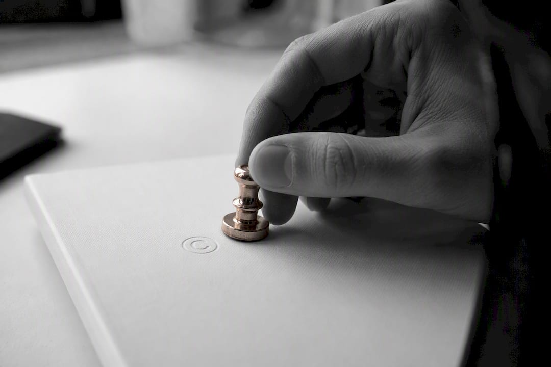 Hand embossing copyright symbol on book cover